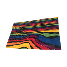 Load image into Gallery viewer, Beach towel with rainbow waves pattern and Threes logo
