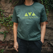 Load image into Gallery viewer, Person wearing Green logo tee
