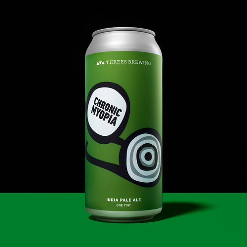 can of beer against green and black background 