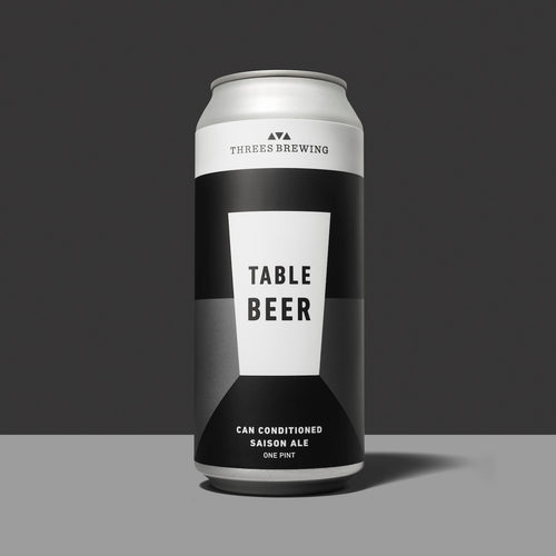 Table Beer can against grey background.